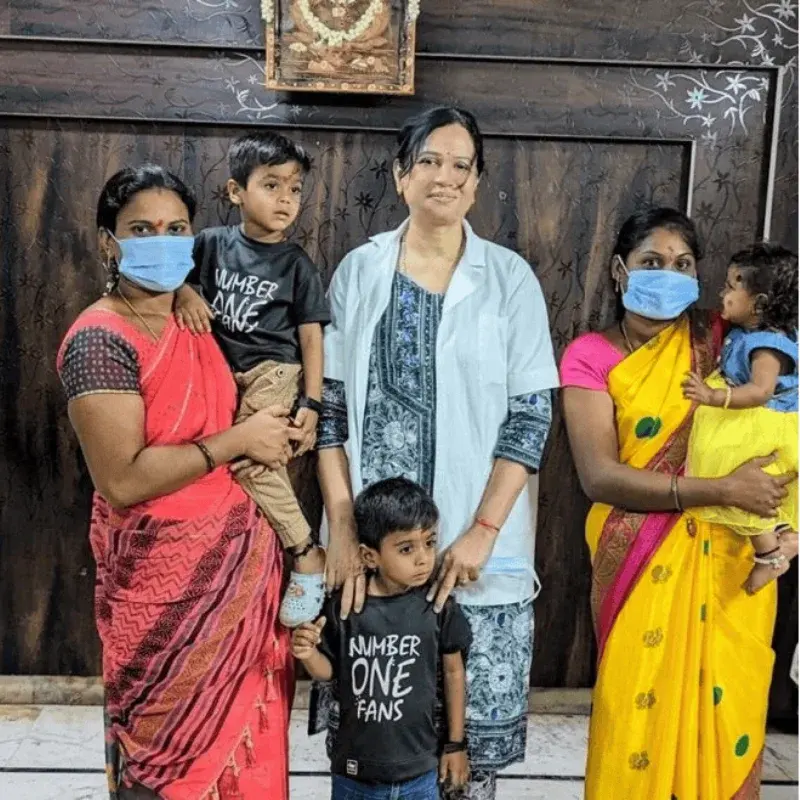 Dr. Padmaja with two families and their three young children at the centre